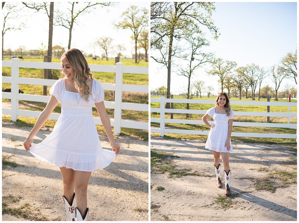 senior girl smiling in a white dress, and aggie boots in front of a white fence. 