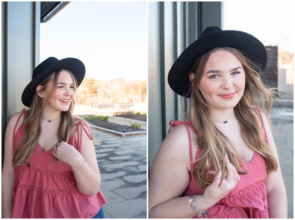 senior portraits of a highschooler in a black cowboy hat and a pink top. This outfit shows off her happy and fun personality.