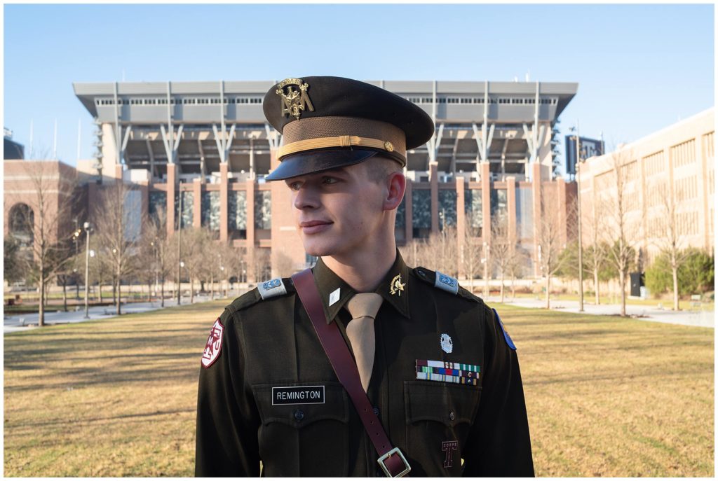 Portrait photo of a corps of cadets student in front of Kyle Field in Aggie Park. 