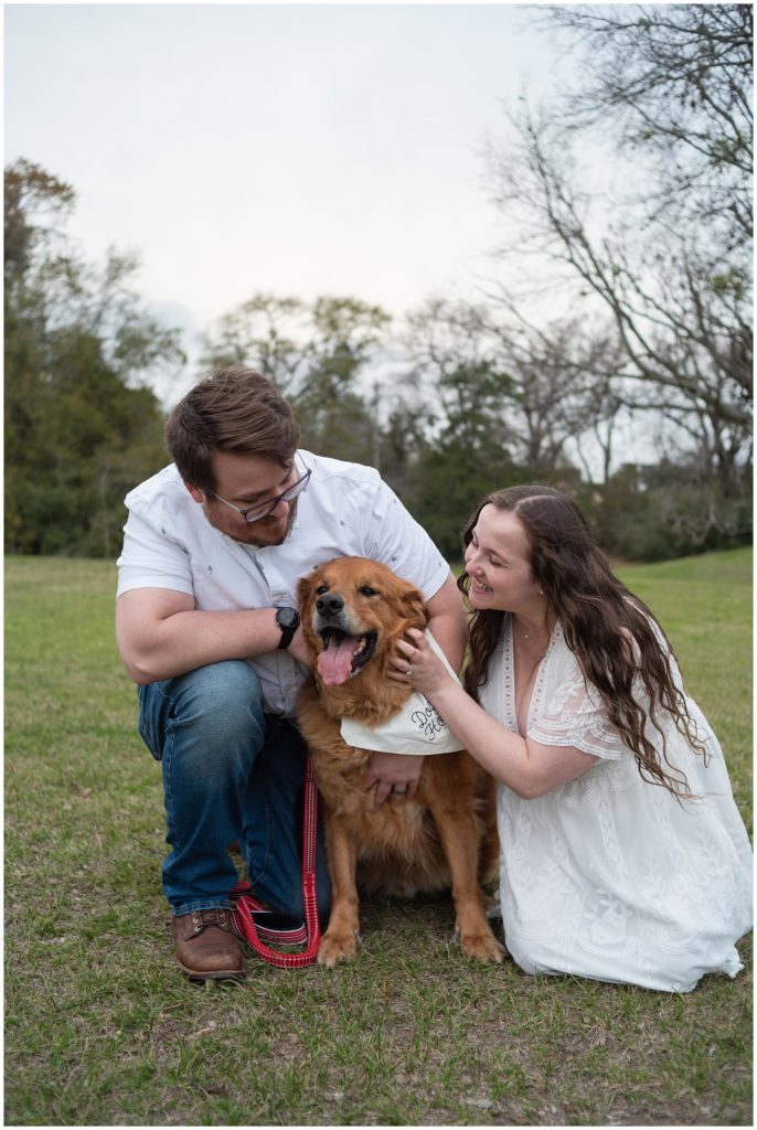 Engagement photos of a couple with their dog at Brison park near Texas A&M in College Station. They could is loving on the dog. 