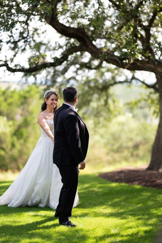 Walking photo of bride and groom. The Hills can be seen blurred in the background