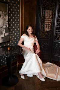 Bride sitting in red chair. 