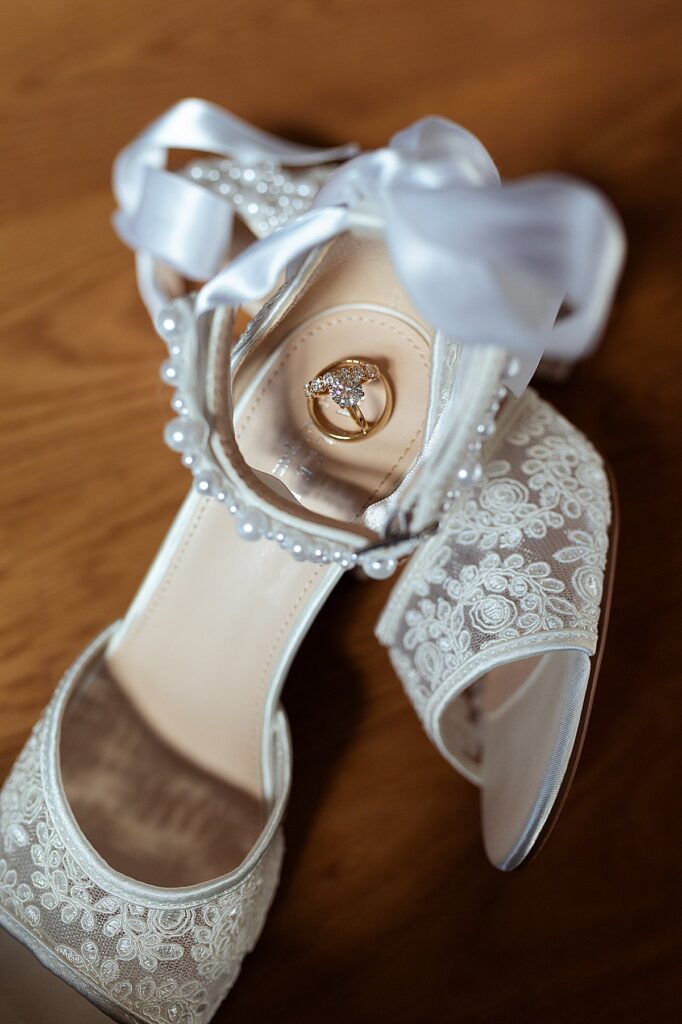 Detail Photo of a bride's shoes and the wedding rings.